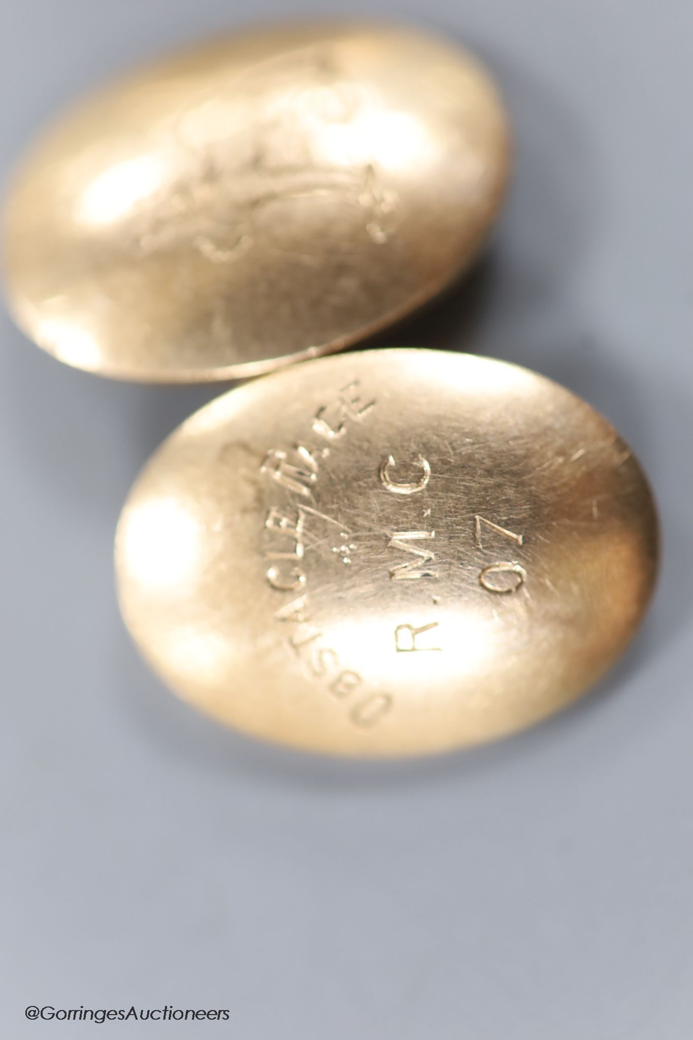 A pair of early 20th century 9ct gold oval cufflinks, engraved with crest and date